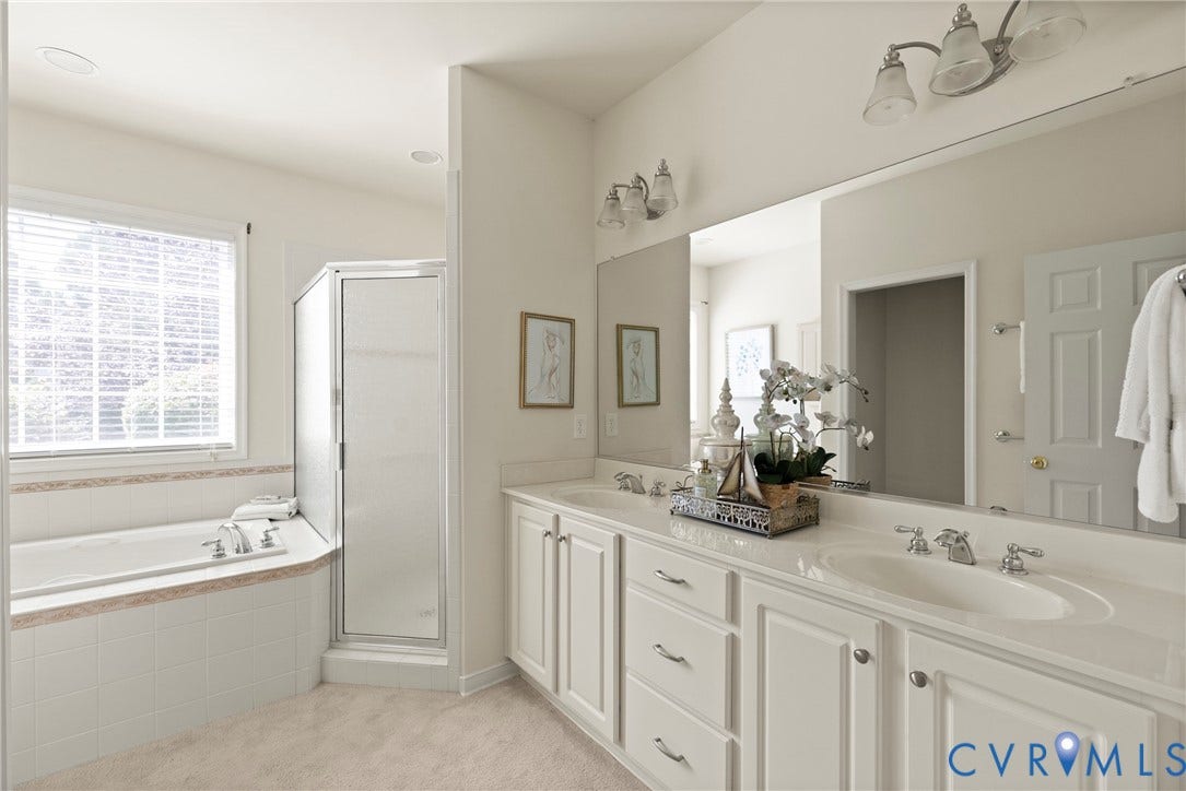 14119 Shawhan Place, Charter Colony, Midlothian, VA 23114 Dual vanity with integrated sinks, large mirror, corner soaking tub, separate glass-enclosed shower, and window with blinds