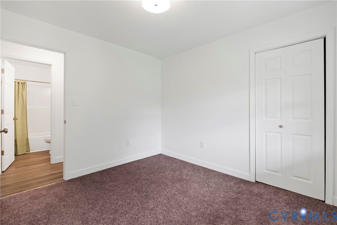 7621 Amelia Springs Road, Amelia, VA 23083 White interior walls, brown carpeting, and a white six-panel bifold closet door