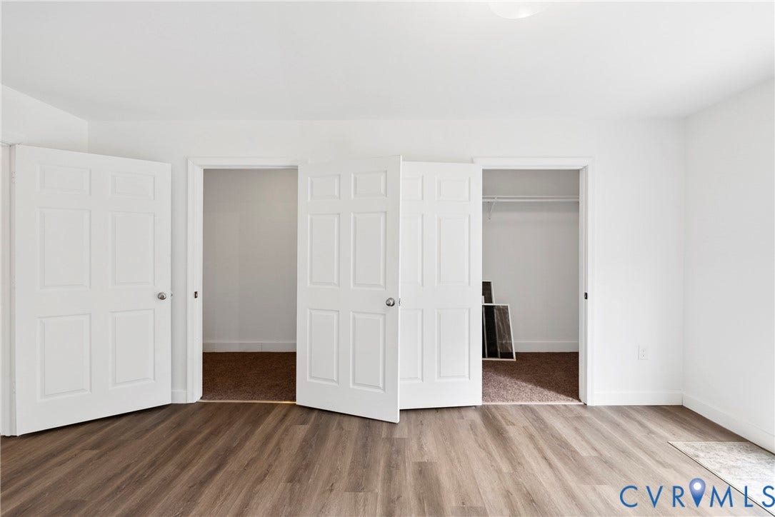 7621 Amelia Springs Road, Amelia, VA 23083 Wood-finish flooring with white walls and trim