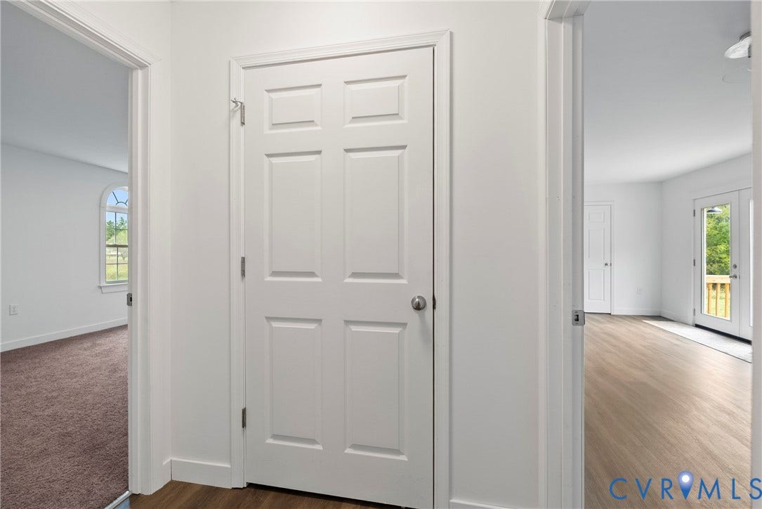 7621 Amelia Springs Road, Amelia, VA 23083 Interior features include wood-finish flooring, white paneled doors, and a room with an arched window
