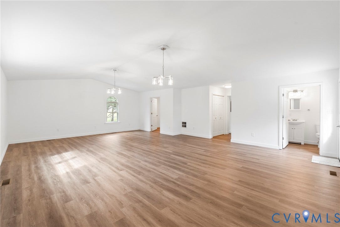7621 Amelia Springs Road, Amelia, VA 23083 Vaulted ceilings with pendant lighting, wood-finish flooring, and a large window