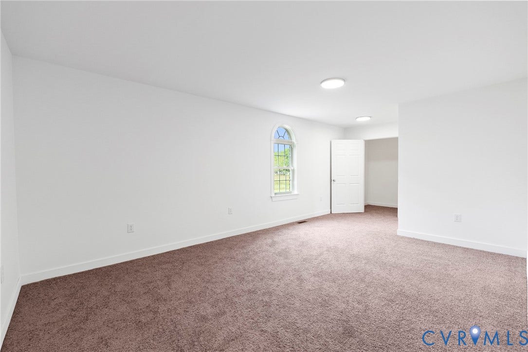 7621 Amelia Springs Road, Amelia, VA 23083 Arched window, recessed lighting, white interior walls, white trim, and brown carpet flooring