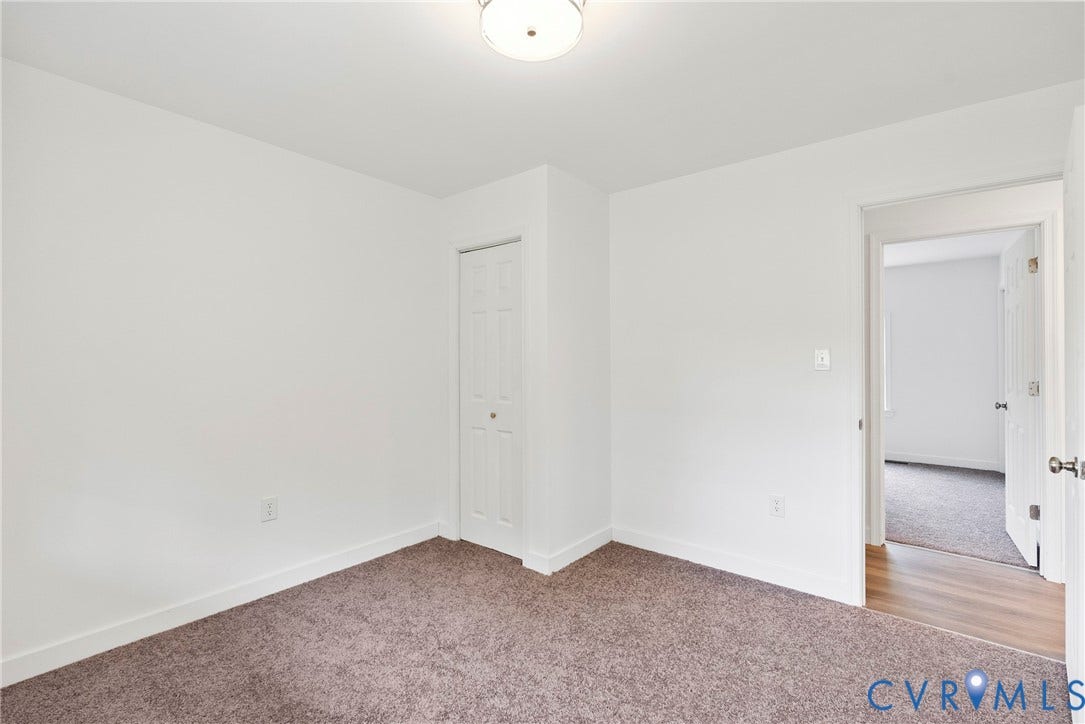 7621 Amelia Springs Road, Amelia, VA 23083 Wall-to-wall carpeting in a neutral tone, white walls, and a ceiling-mounted light fixture