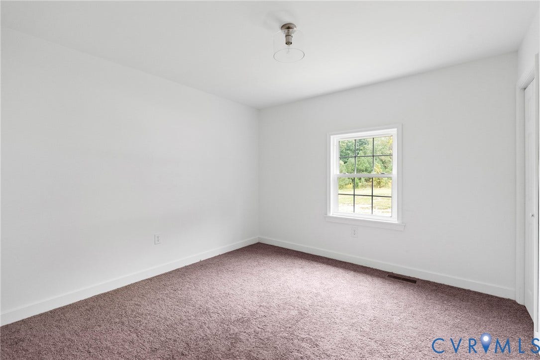 7621 Amelia Springs Road, Amelia, VA 23083 Neutral wall paint, carpeted flooring, a single window, and a flush-mount ceiling fixture