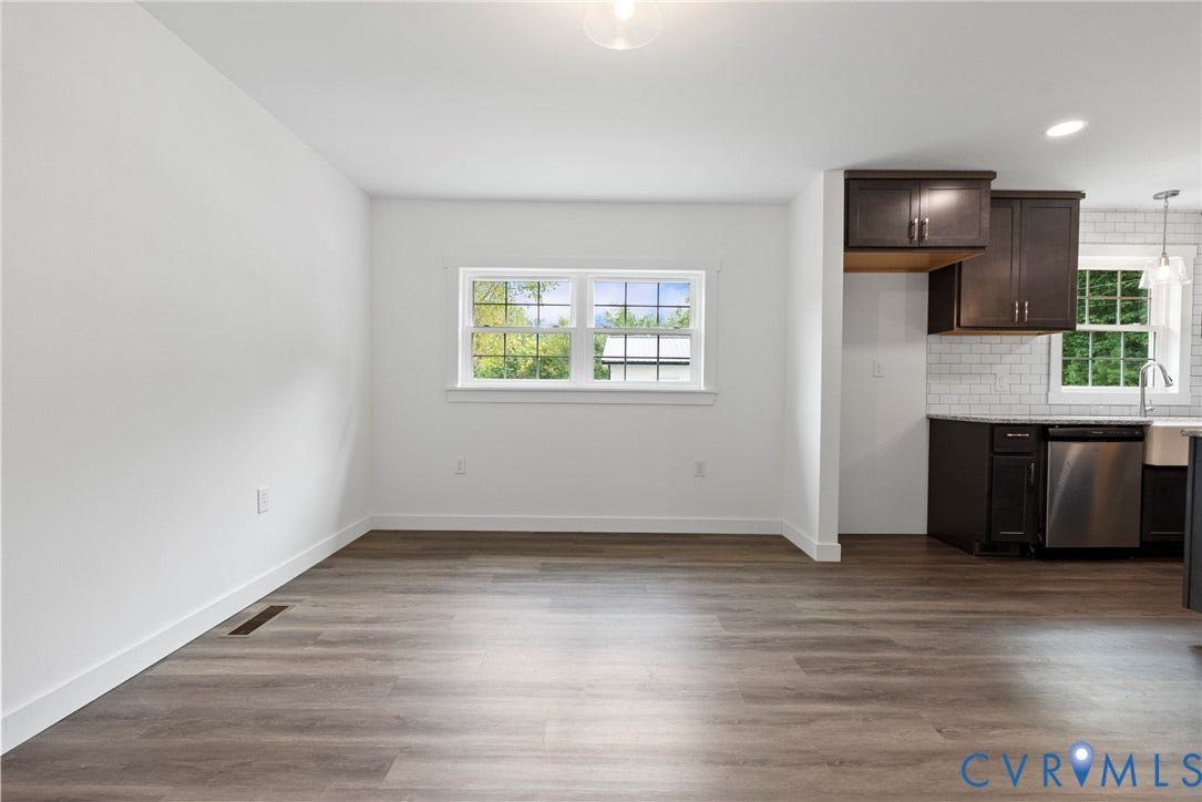 7621 Amelia Springs Road, Amelia, VA 23083 Light wood-finish flooring, white walls, and a window with white trim