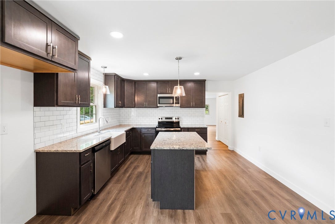 7621 Amelia Springs Road, Amelia, VA 23083 Kitchen featuring dark wood cabinetry, light-toned countertops, subway tile backsplash, stainless steel appliances, and wood-finish flooring