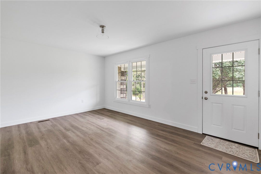 7621 Amelia Springs Road, Amelia, VA 23083 White interior walls, wood-finish flooring, white trim, and white paneled door with window