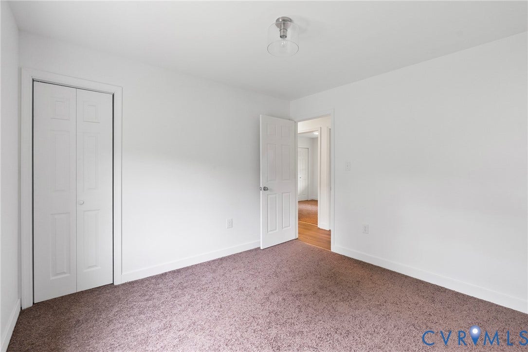 7621 Amelia Springs Road, Amelia, VA 23083 Neutral wall color with carpet flooring and bi-fold closet doors