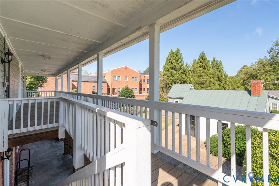 13085 W James Anderson Highway, Buckingham, VA 23921 Covered exterior porch with wood-finish flooring and white railings