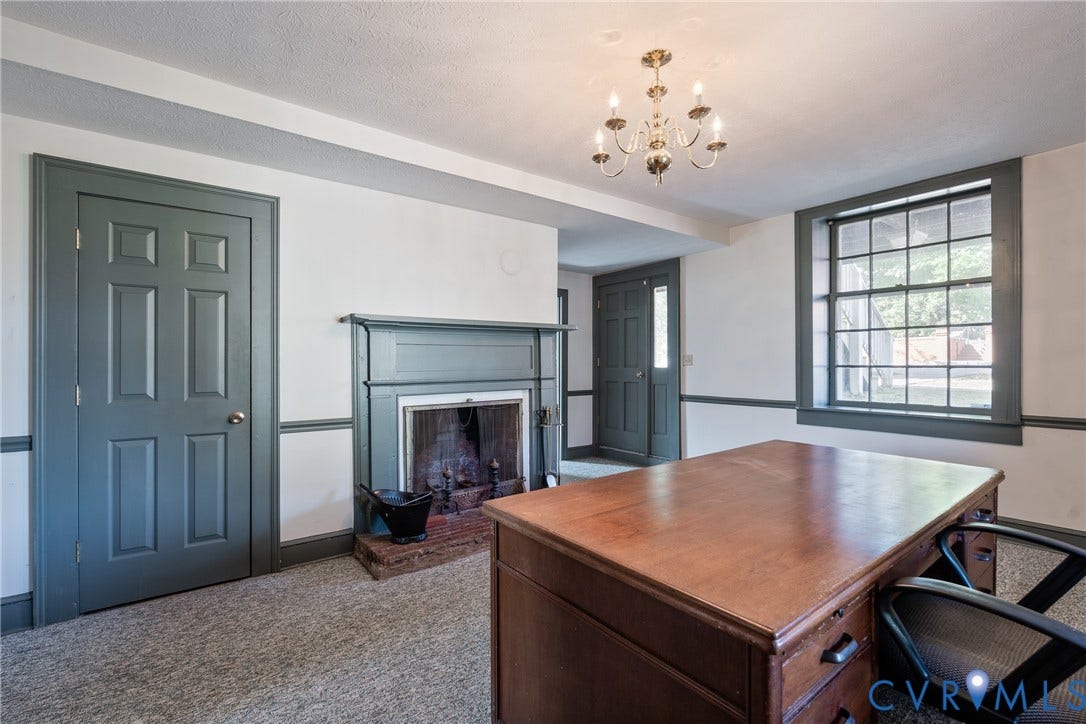 13085 W James Anderson Highway, Buckingham, VA 23921 Chandelier lighting, decorative fireplace, paneled doors, and large window