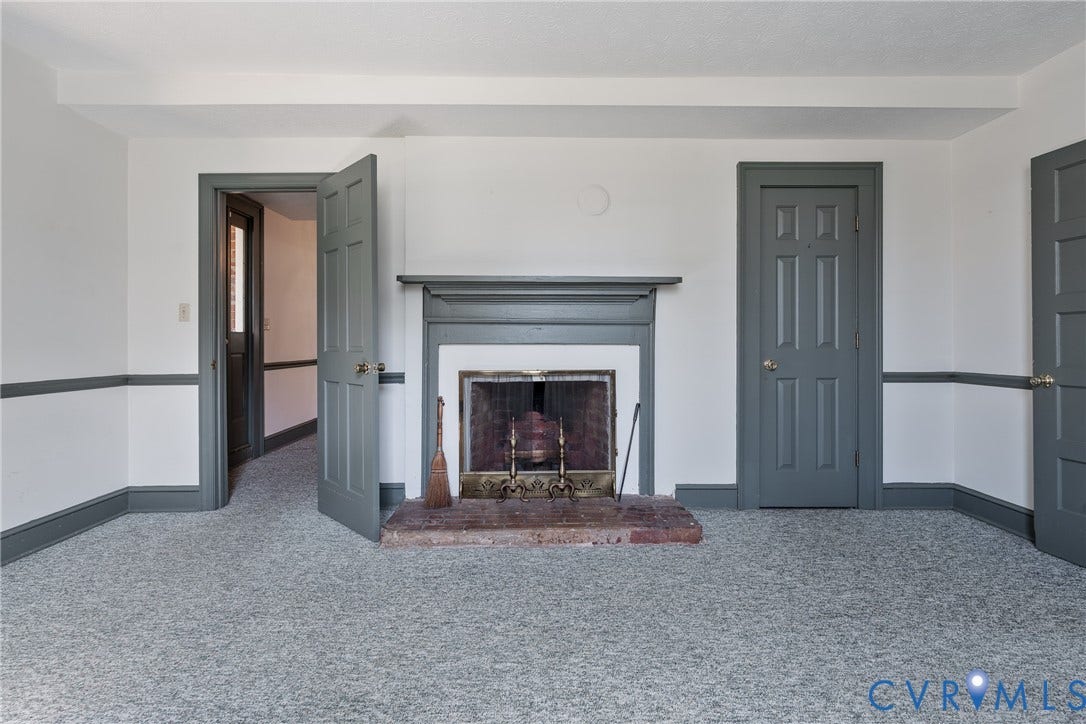 13085 W James Anderson Highway, Buckingham, VA 23921 Carpeted room with a fireplace featuring a stone hearth and mantel