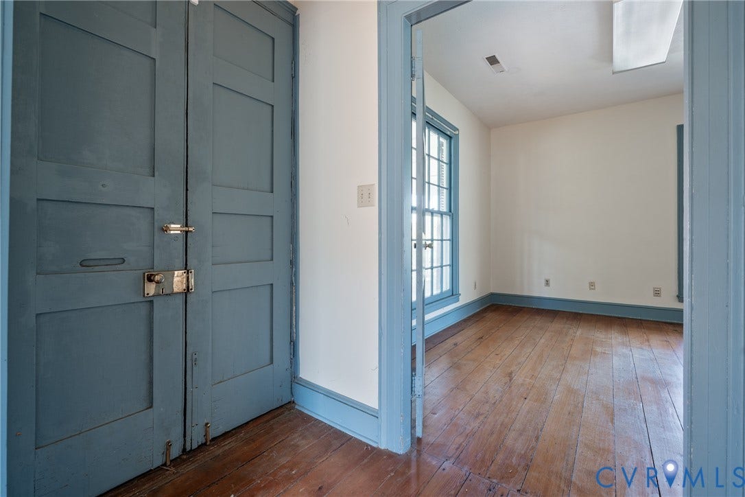 13085 W James Anderson Highway, Buckingham, VA 23921 Wood-finish flooring, paneled interior doors, and a multi-pane window with blue trim