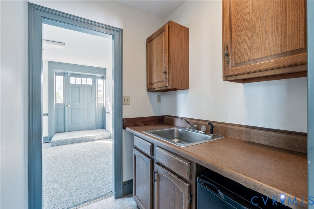 13085 W James Anderson Highway, Buckingham, VA 23921 Built-in wet bar with wood cabinetry, stainless steel sink, and countertop