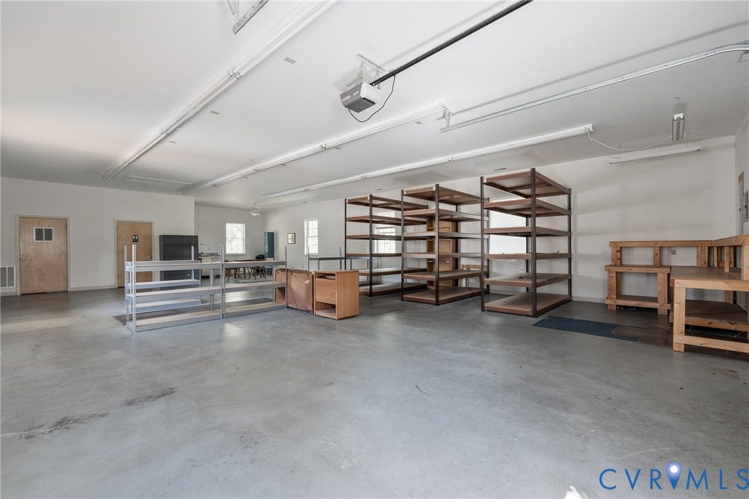 13085 W James Anderson Highway, Buckingham, VA 23921 Expansive interior space featuring concrete flooring, multiple windows, and extensive overhead lighting