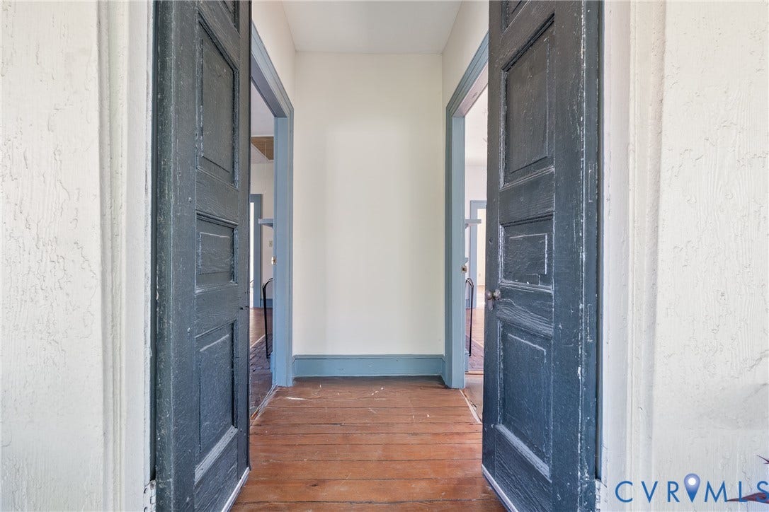 13085 W James Anderson Highway, Buckingham, VA 23921 Wood-finish flooring with baseboard trim, paneled doors, and painted door frames
