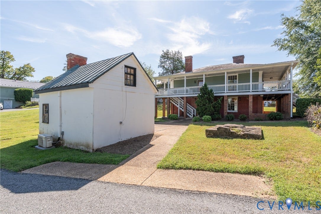 13085 W James Anderson Highway, Buckingham, VA 23921 Two-story residence featuring brick foundation, white railing, and a covered porch
