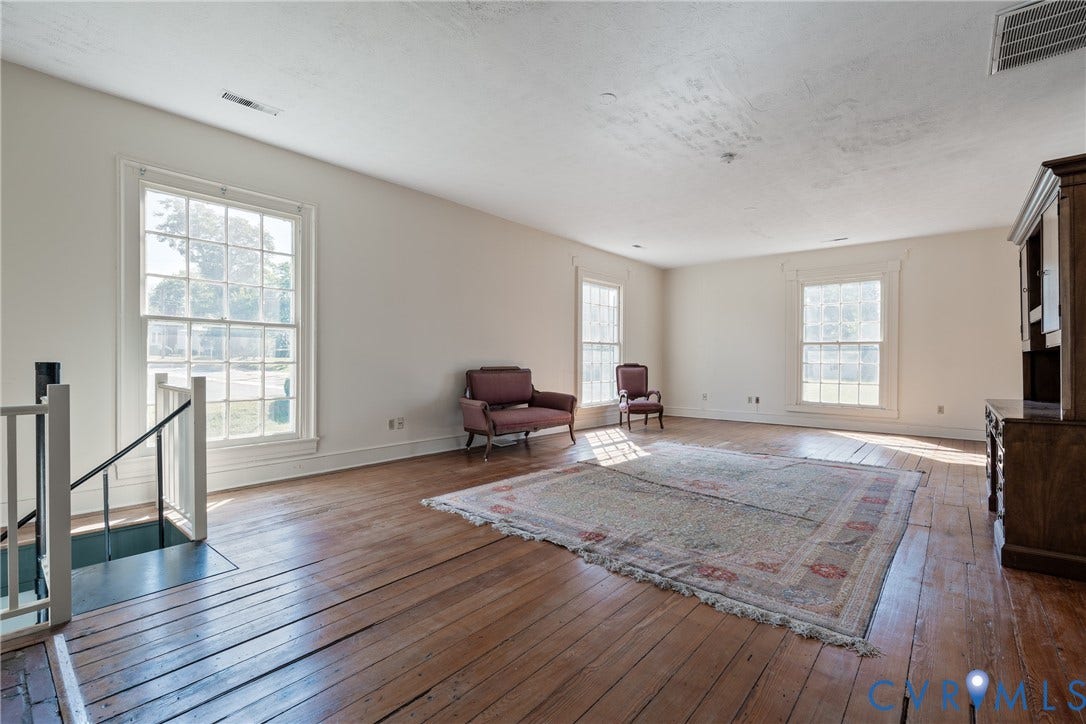 13085 W James Anderson Highway, Buckingham, VA 23921 Hardwood flooring throughout, multiple large windows, and a built-in wooden cabinet