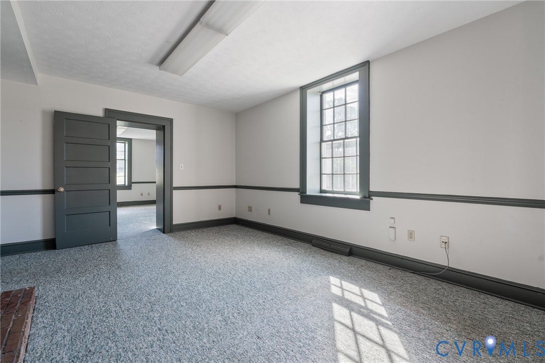 13085 W James Anderson Highway, Buckingham, VA 23921 Recessed fluorescent ceiling light, durable flooring, multi-pane window, solid panel door, and dark trim accents