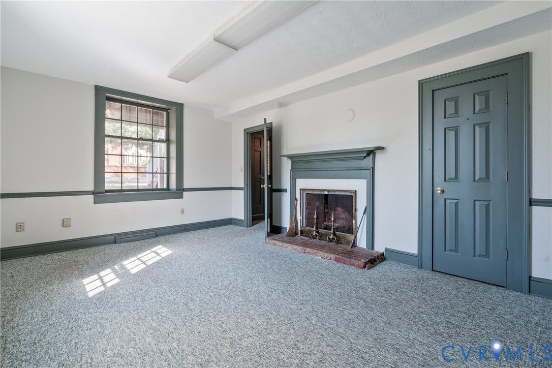 13085 W James Anderson Highway, Buckingham, VA 23921 Recessed fireplace with hearth, paneled interior doors, crown molding, and window with grid pattern