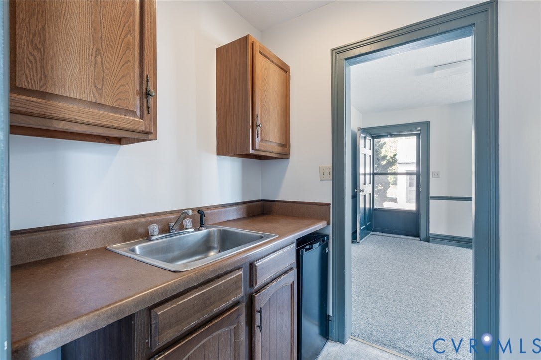 13085 W James Anderson Highway, Buckingham, VA 23921 Built-in cabinetry with wood-finish doors, stainless steel sink, and durable countertop