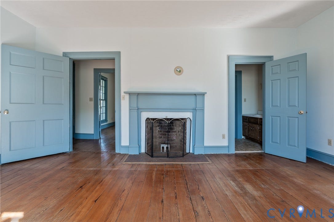 13085 W James Anderson Highway, Buckingham, VA 23921 Hardwood flooring, painted fireplace mantel, traditional six-panel doors, and white walls