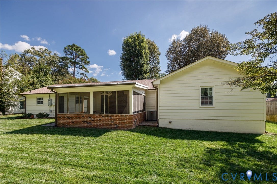 3356 Seaton Road, Petersburg, VA 23805 Expansive backyard featuring a screened porch with brick base, lush green lawn, and mature trees