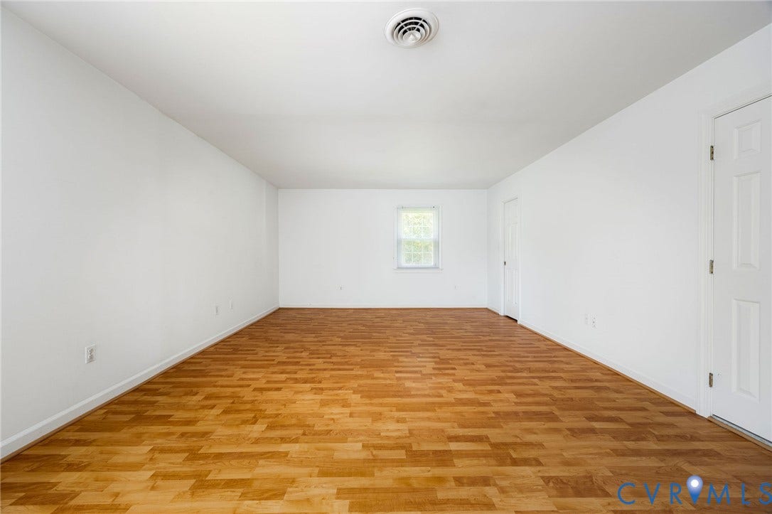 3356 Seaton Road, Petersburg, VA 23805 Primary suite with wood like flooring, crisp white walls. 3 closets. Attached full bath. 2 windows.