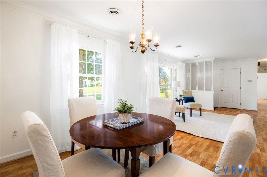 3356 Seaton Road, Petersburg, VA 23805 Hardwood flooring, crown molding, white walls, and a multi-light chandelier