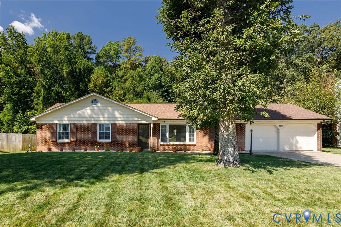 3356 Seaton Road, Petersburg, VA 23805 Brick exterior with light-colored siding, a two-car garage, and a lush front lawn