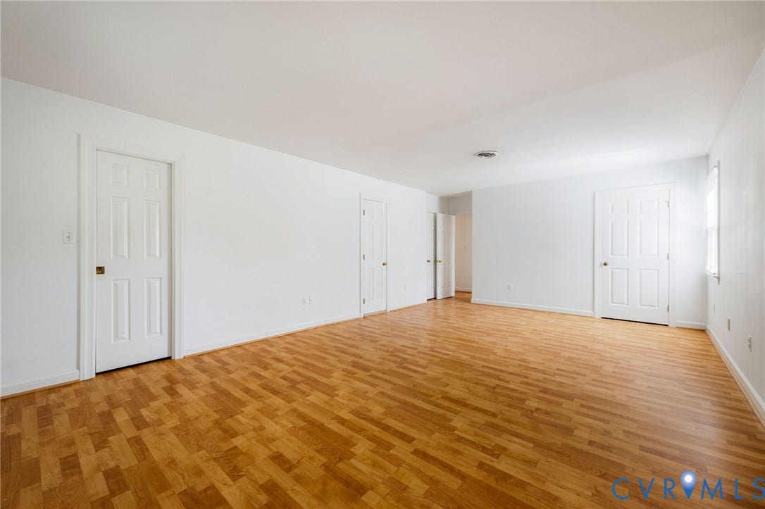 3356 Seaton Road, Petersburg, VA 23805 Expansive room featuring wood-finish flooring, white walls, and multiple paneled doors