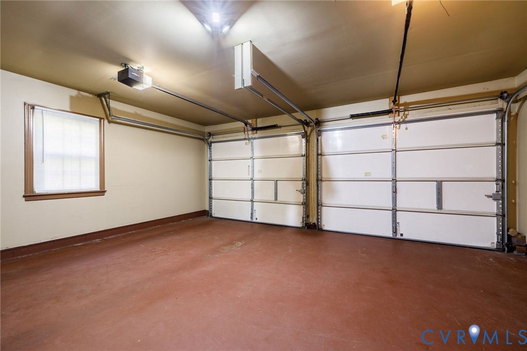 3356 Seaton Road, Petersburg, VA 23805 Two overhead garage doors with automatic openers, a single window, and painted concrete flooring