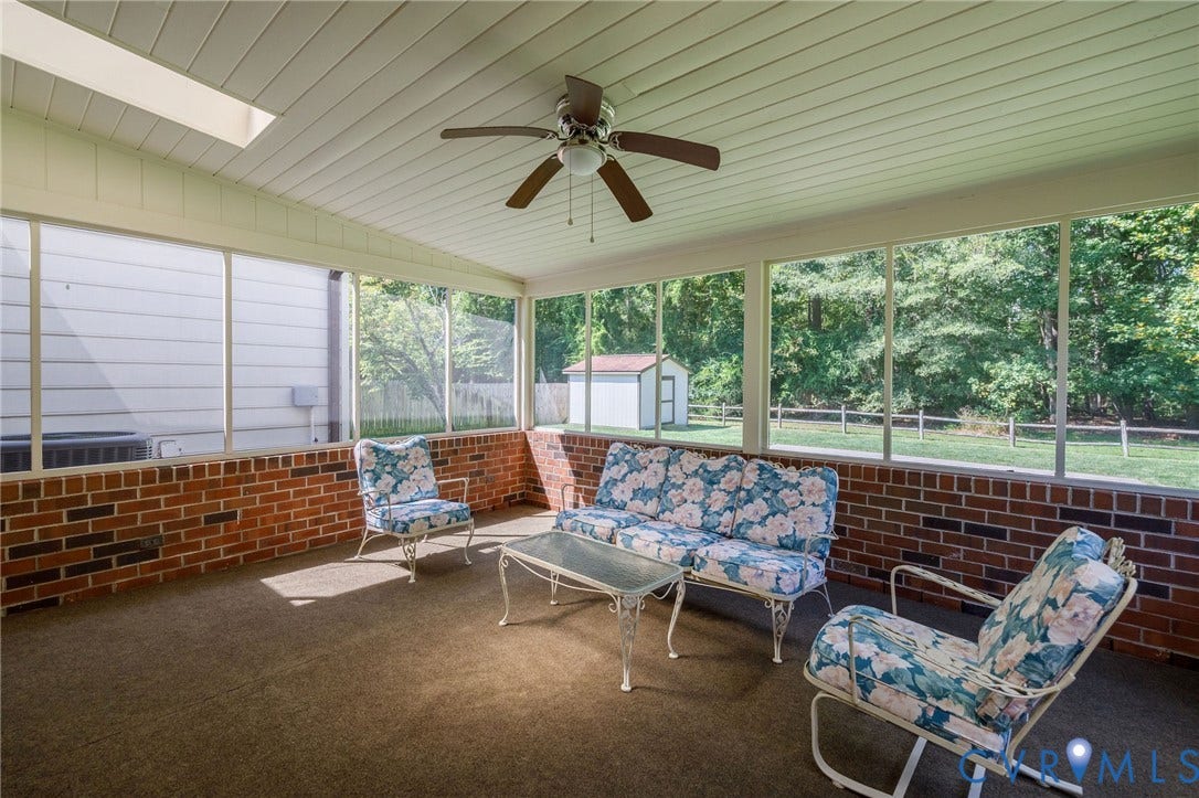 3356 Seaton Road, Petersburg, VA 23805 Screened porch featuring a brick half-wall, skylight, and ceiling fan