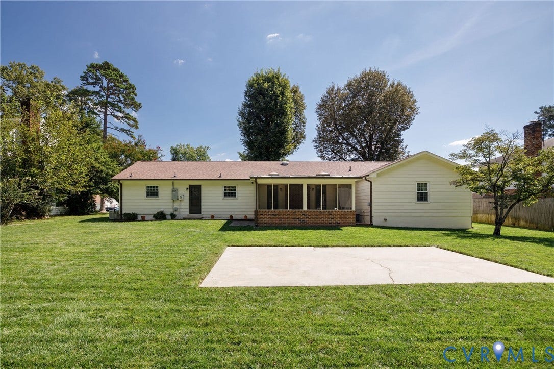 3356 Seaton Road, Petersburg, VA 23805 Expansive rear lawn featuring a large concrete patio, screened porch, and mature perimeter trees
