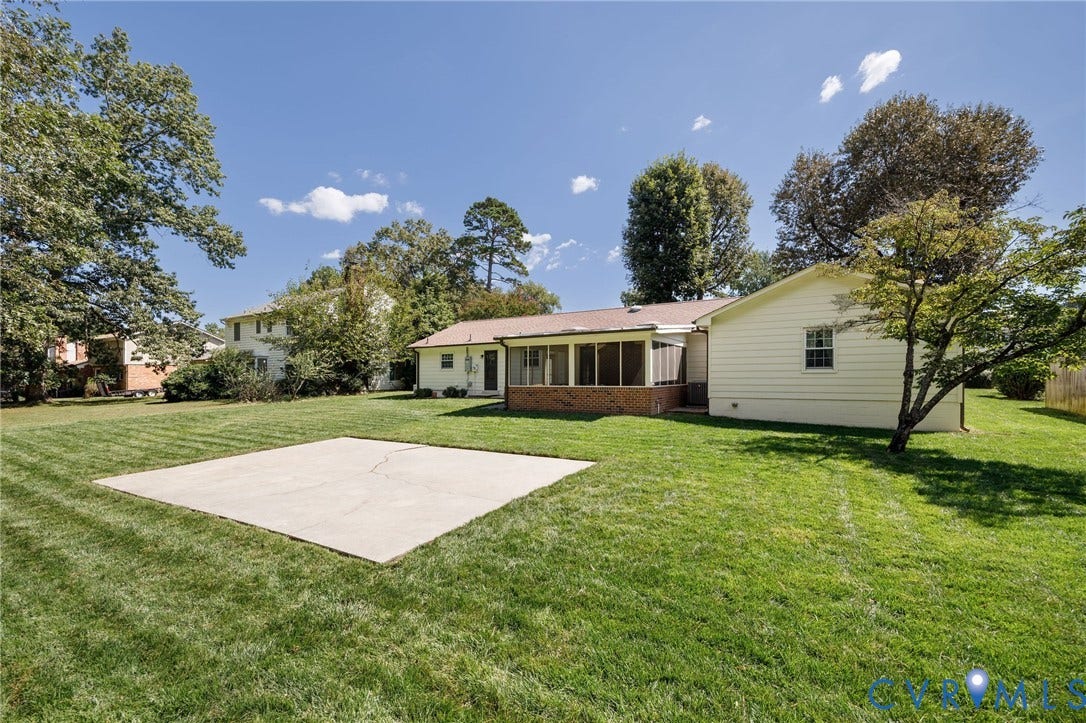 3356 Seaton Road, Petersburg, VA 23805 Expansive backyard featuring a concrete patio, screened-in porch, and mature trees