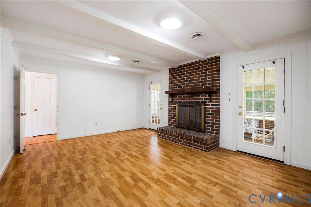 3356 Seaton Road, Petersburg, VA 23805 Wood-finish flooring, ceiling beams, and a brick fireplace (non-working) with a wood mantle.