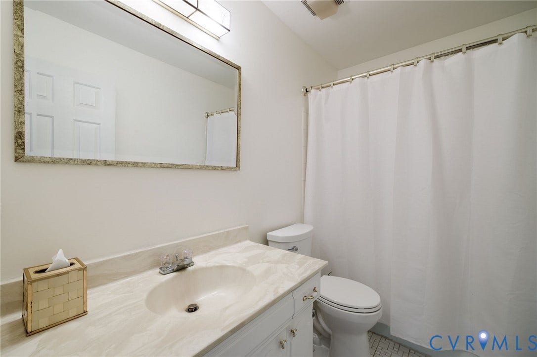 3356 Seaton Road, Petersburg, VA 23805 Hall bath with tub/shower combination with tile surround and tile floor. Vanity with an integrated sink and storage.