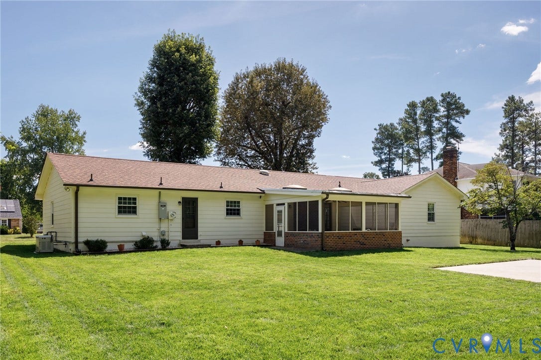 3356 Seaton Road, Petersburg, VA 23805 Expansive backyard featuring a large concrete patio, screened-in porch with brick foundation, and mature trees