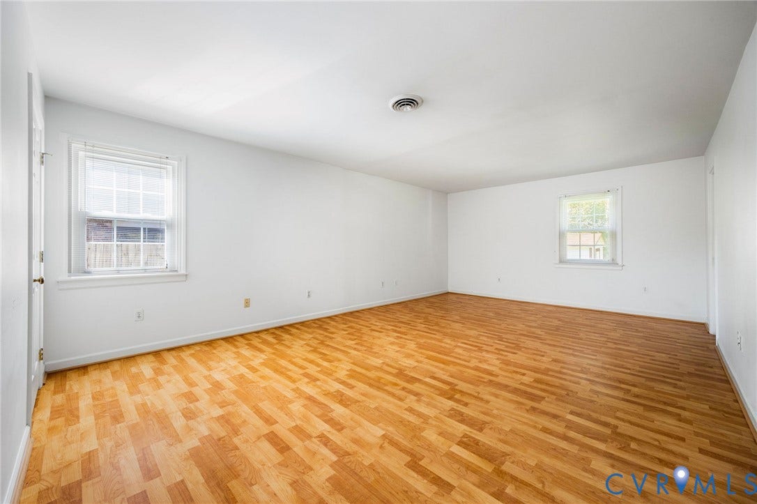 3356 Seaton Road, Petersburg, VA 23805 Spacious room featuring wood-finish flooring, white walls, and multiple windows