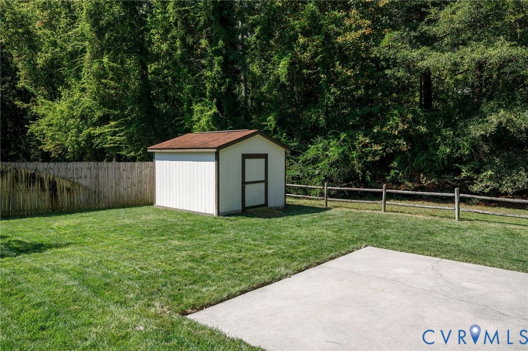 3356 Seaton Road, Petersburg, VA 23805 Manicured lawn with a storage shed, concrete patio, and wood privacy fencing