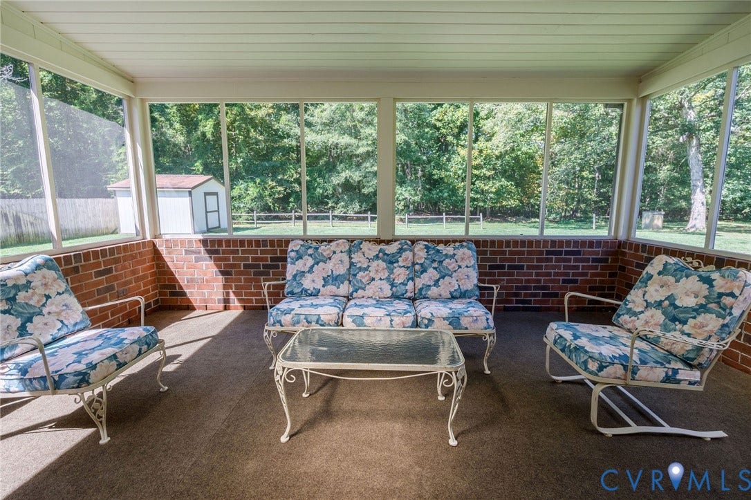 3356 Seaton Road, Petersburg, VA 23805 Screened-in porch featuring brick wainscoting and a carpeted floor