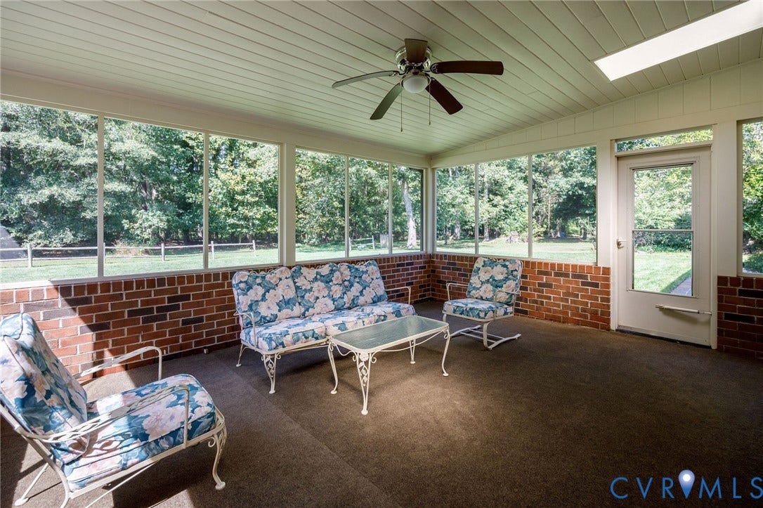 3356 Seaton Road, Petersburg, VA 23805 Screened porch featuring brick knee walls, a ceiling fan, and a wood-panel ceiling