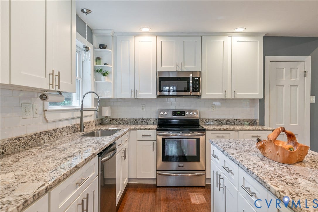 4327 Wakefield Road, Stratford Hills, Richmond, VA 23235 White shaker-style cabinetry with brushed nickel hardware, light-toned stone countertops, and stainless steel appliances