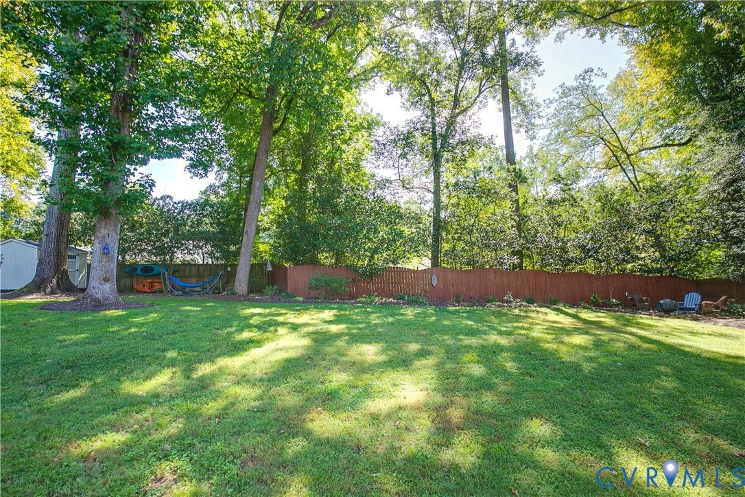4327 Wakefield Road, Stratford Hills, Richmond, VA 23235 Expansive green lawn with mature trees and a wood privacy fence