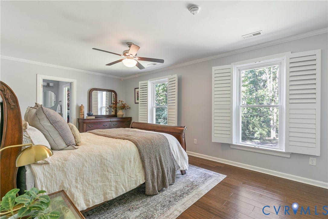 4327 Wakefield Road, Stratford Hills, Richmond, VA 23235 Wood-finish flooring, ceiling fan with integrated lighting, crown molding, white plantation shutters, and a doorway opening to an additional room