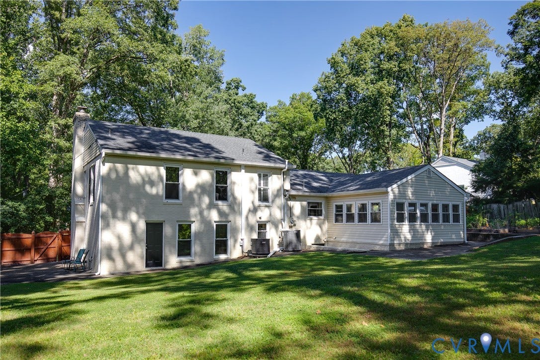 4327 Wakefield Road, Stratford Hills, Richmond, VA 23235 Expansive green lawn with mature trees and a multi-level home featuring an extended sunroom with multiple windows