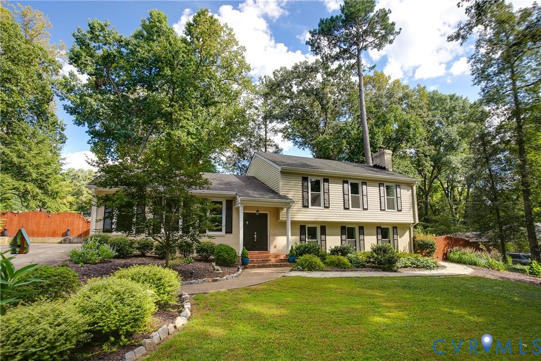4327 Wakefield Road, Stratford Hills, Richmond, VA 23235 Two-story residence featuring light-colored siding, black window shutters, a prominent chimney, and a dark front door