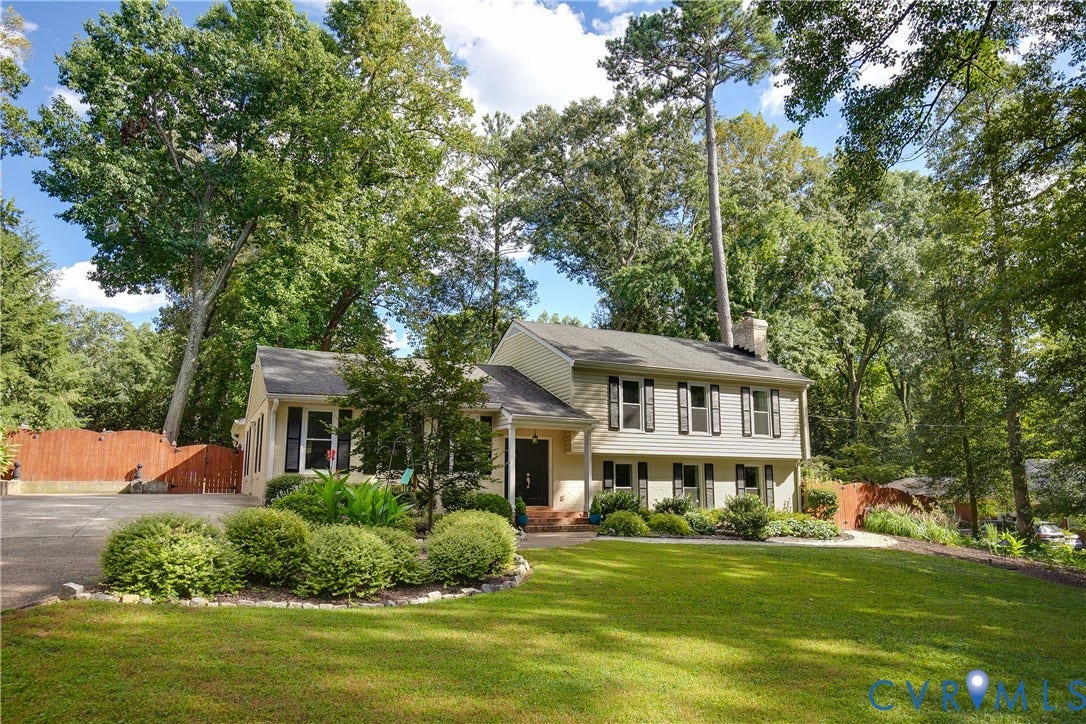 4327 Wakefield Road, Stratford Hills, Richmond, VA 23235 Two-story residence with a light-colored siding exterior, dark shutters, and a dark shingle roof