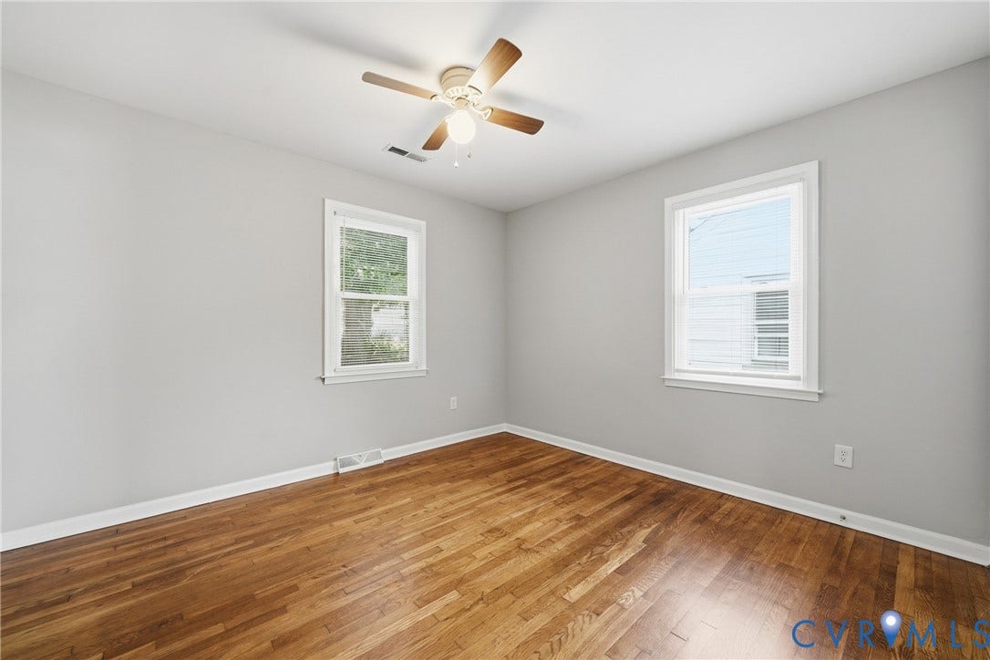 1718 Rogers, Richmond, VA 23223 Hardwood flooring, light gray wall paint, white window trim, dual windows, and a ceiling fan with light fixture