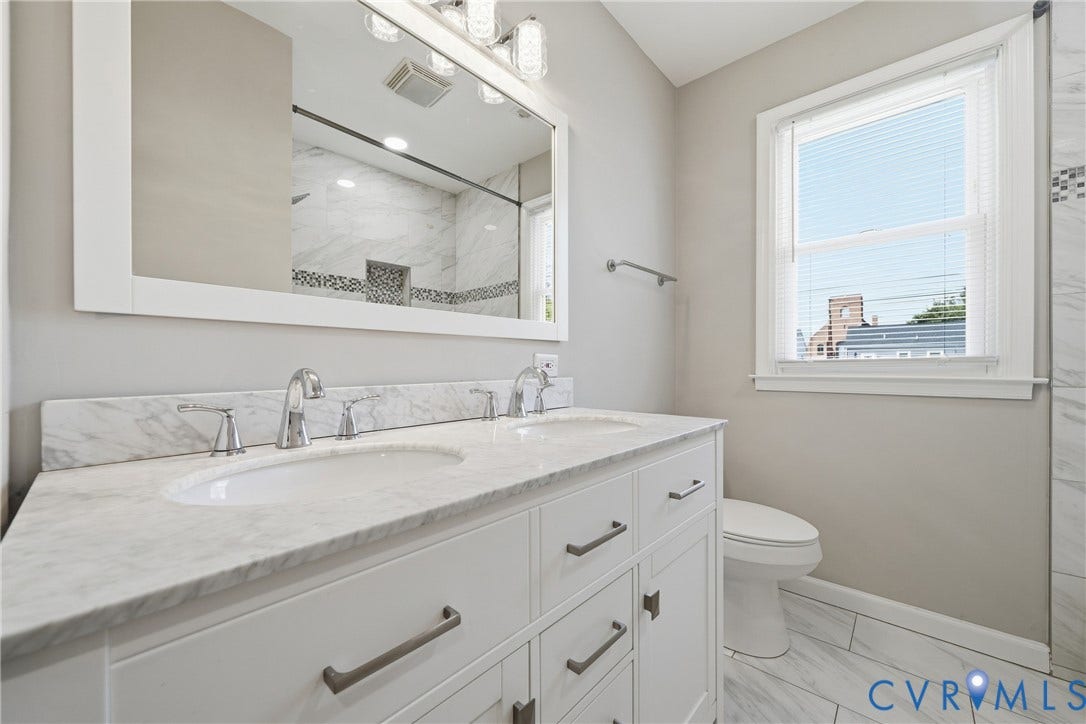 1718 Rogers, Richmond, VA 23223 Dual vanity with marble-finish countertop, white cabinetry, and brushed nickel hardware
