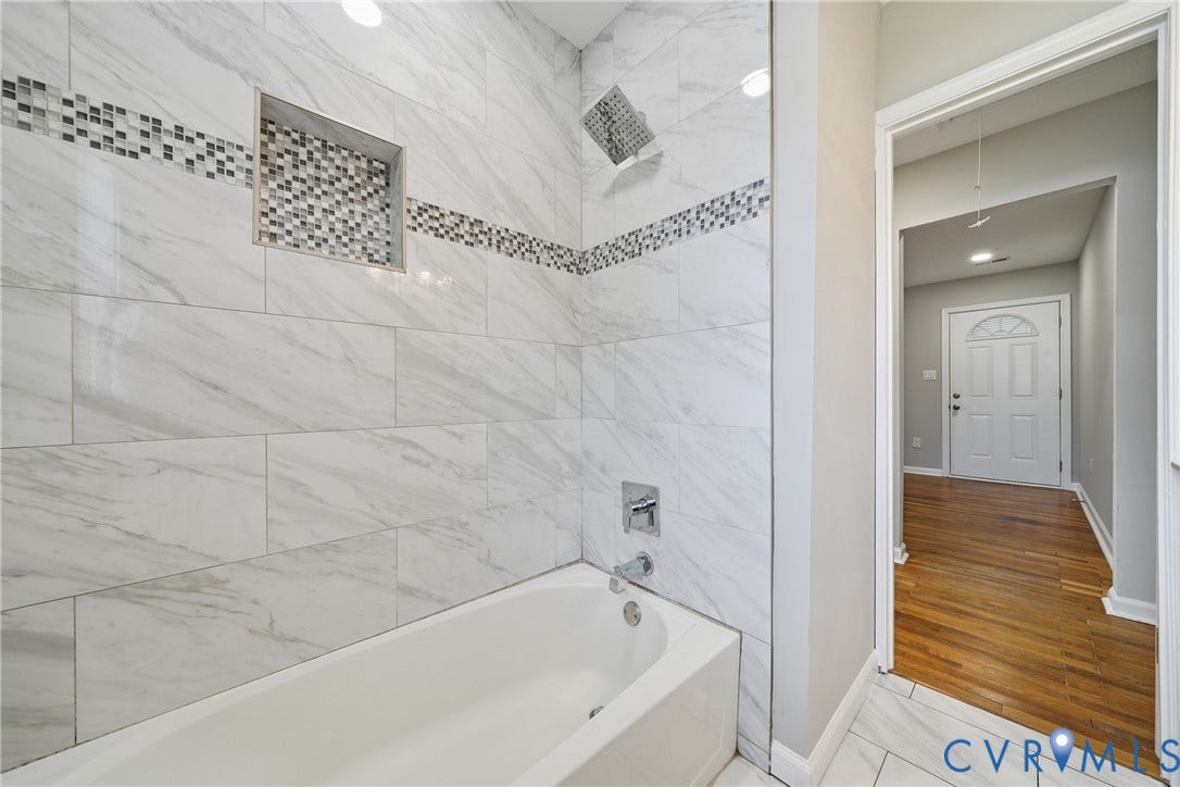 1718 Rogers, Richmond, VA 23223 Bathtub with large format wall tiling, mosaic tile accent, and recessed shower niche